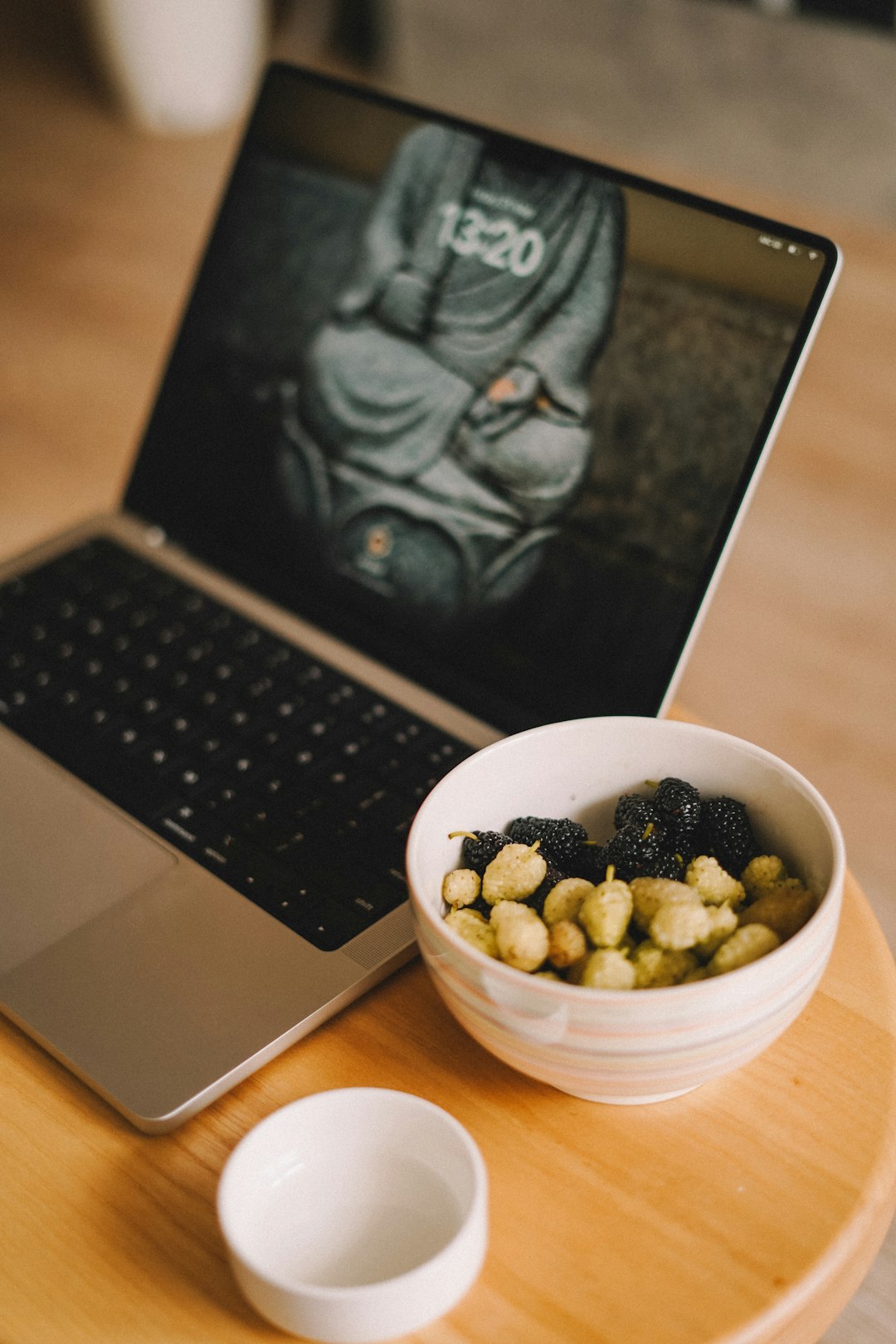 a-bowl-of-cereal-next-to-a-laptop-on-a-table-xdro16bgofq